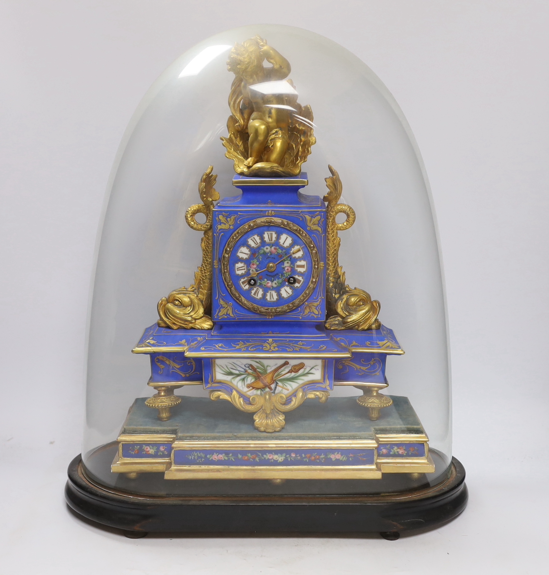 A 19th century French porcelain and gilt mantel clock under glass dome, striking on a bell, the face signed Muller, 48cm high, under dome